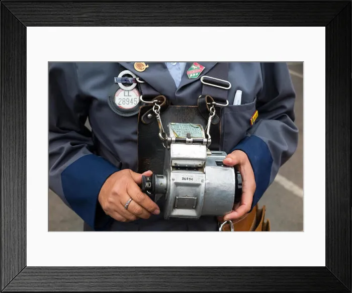 Framed Print : London Transport ticket machine used by bus conductor issuing tickets to passengers / passenger on buses in 1970 1980 Framed Print : London Transport ticket machine used by bus conductor issuing tickets to passengers / passenger on buses in 1970 1980