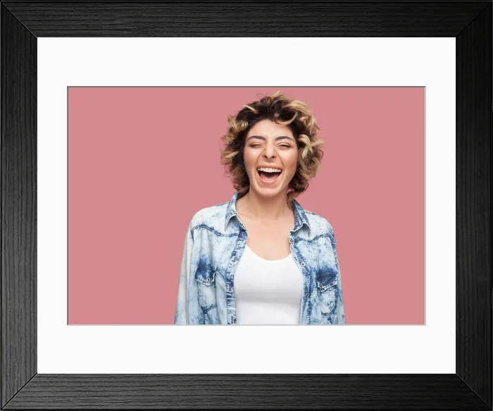Framed Print : Portrait of happy laughter young woman with curly hairstyle in casual blue shirt standing Framed Print : Portrait of happy laughter young woman with curly hairstyle in casual blue shirt standing
