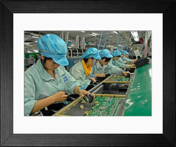 Framed Print : FILE--Chinese migrant workers labor at an electronics factory in Dongguan city Framed Print : FILE--Chinese migrant workers labor at an electronics factory in Dongguan city