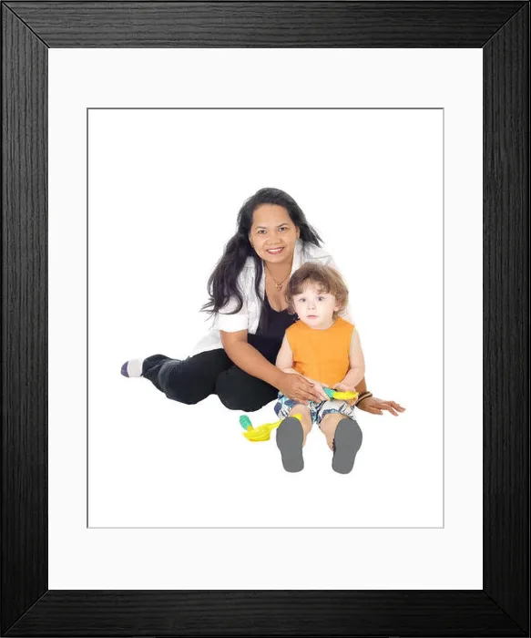 Framed Print : A Filipino nanny sitting on the floor playing with a little three year old boy, isolated for white background Framed Print : A Filipino nanny sitting on the floor playing with a little three year old boy, isolated for white background