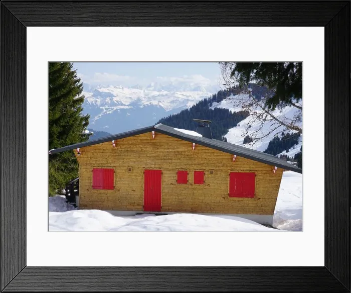 Framed Print : typical wooden chalet with red shutters in the Alps, France on the ski slopes with a panorama Framed Print : typical wooden chalet with red shutters in the Alps, France on the ski slopes with a panorama