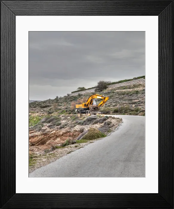 Framed Print : Yellow Bulldozer Coming Down An Empty Seaside Road. Stock Image Framed Print : Yellow Bulldozer Coming Down An Empty Seaside Road. Stock Image