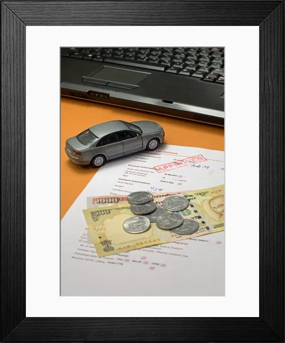 Framed Print : Toy car with loan application form, indian rupees and a laptop Framed Print : Toy car with loan application form, indian rupees and a laptop
