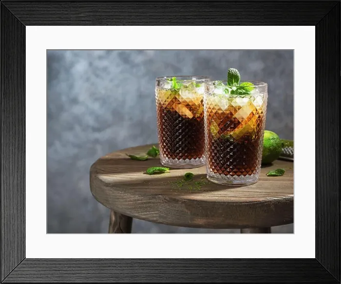 Framed Print : Two glasses of Cuba Libre cocktail on wooden table Framed Print : Two glasses of Cuba Libre cocktail on wooden table