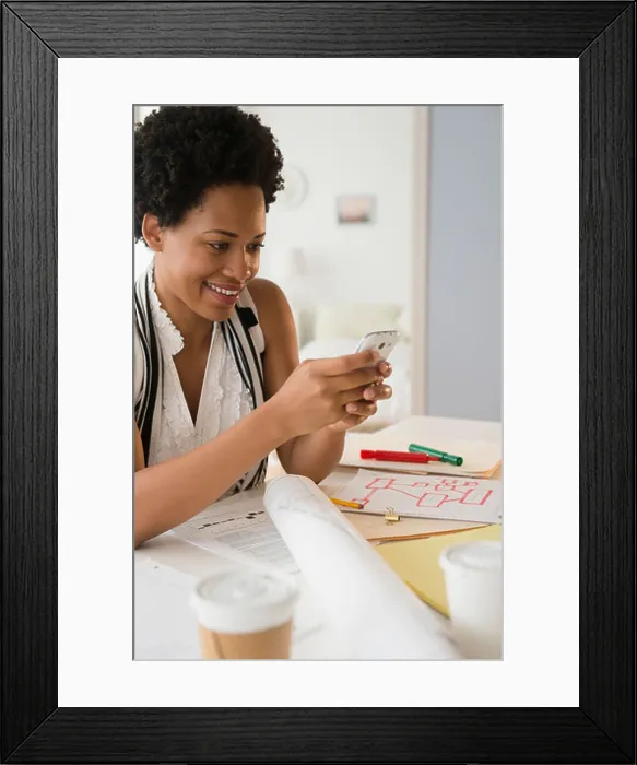 Framed Print : Black businesswoman using cell phone Framed Print : Black businesswoman using cell phone