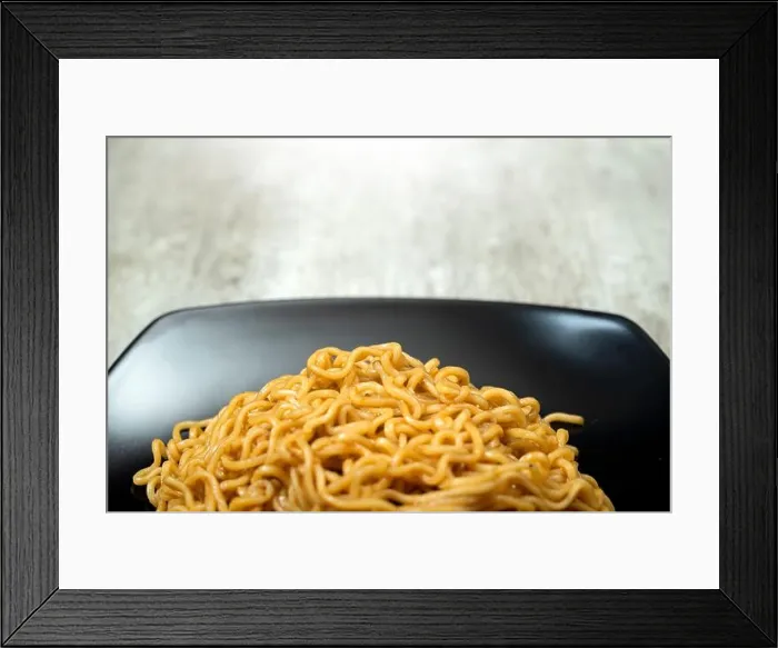 Framed Print : A plate of instant noodles sits on a table Framed Print : A plate of instant noodles sits on a table
