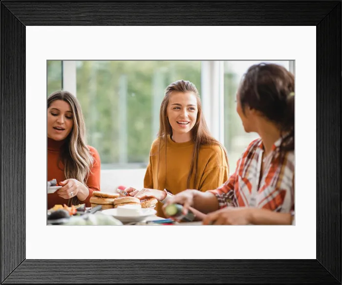 Framed Print : young female adult talking to her friend while having a healthy lunch Framed Print : young female adult talking to her friend while having a healthy lunch