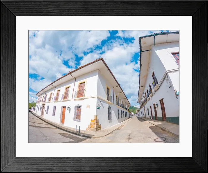 Framed Print : Charming street scene in Popayán, Colombia, featuring traditional white buildings and a clear blue sky Framed Print : Charming street scene in Popayán, Colombia, featuring traditional white buildings and a clear blue sky