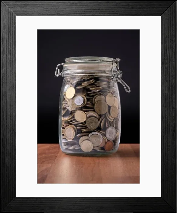 Framed Print : Coins inside a glass container full of money Framed Print : Coins inside a glass container full of money