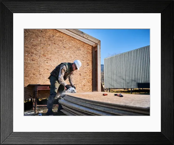 Framed Print : Carpenter using circular saw for cutting wooden OSB board Framed Print : Carpenter using circular saw for cutting wooden OSB board
