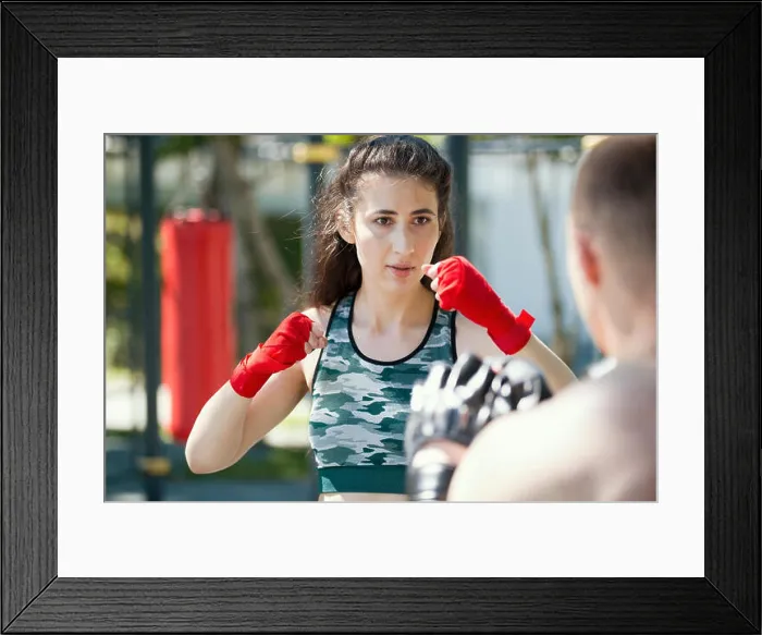 Framed Print : Boxers - muscular man and young woman engaged in boxing in the park ar sunny day Framed Print : Boxers - muscular man and young woman engaged in boxing in the park ar sunny day