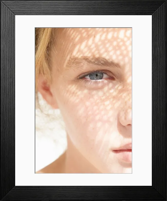 Framed Print : A young woman looking at the camera Framed Print : A young woman looking at the camera