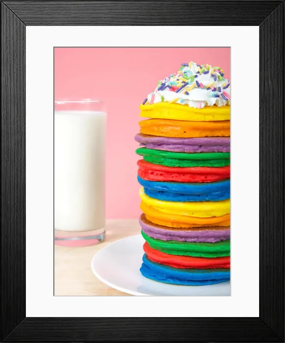 Framed Print : Stack of bright colorful pancakes topped with whipped cream and candy sprinkles with pink background and glass of milk Framed Print : Stack of bright colorful pancakes topped with whipped cream and candy sprinkles with pink background and glass of milk