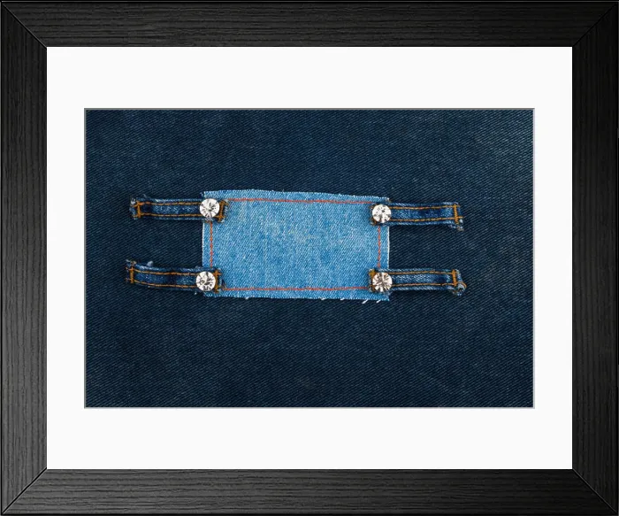 Framed Print : Frame with four straps jeans and rhinestones, lies on the dark denim, with space for your text Framed Print : Frame with four straps jeans and rhinestones, lies on the dark denim, with space for your text