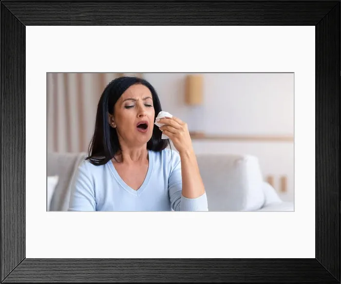 Framed Print : Sick mature woman sneezing and couching, holding tissue paper