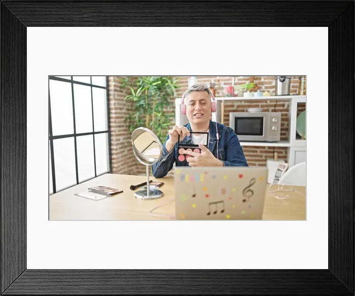 Framed Print : Young caucasian man recording make up video tutorial at dinning room Framed Print : Young caucasian man recording make up video tutorial at dinning room