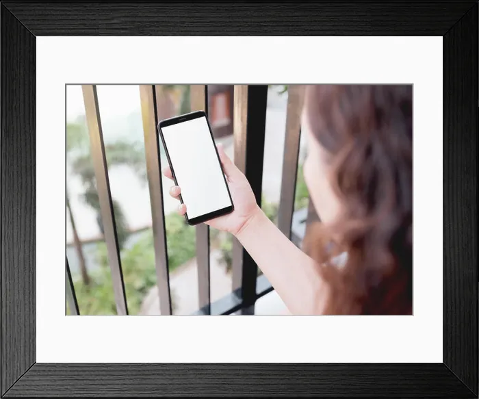 Framed Print : Mockup image of a woman using smart phone with blank white screen at home Framed Print : Mockup image of a woman using smart phone with blank white screen at home