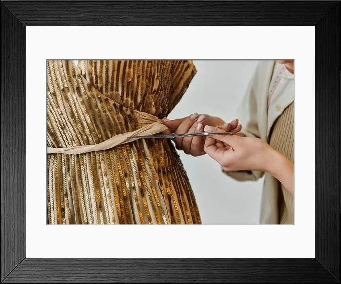 Framed Print : A young woman in casual attire upcycling clothes, cutting fabric with scissors Framed Print : A young woman in casual attire upcycling clothes, cutting fabric with scissors