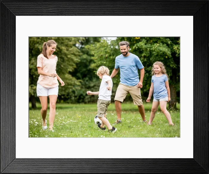 Framed Print : Family and kids play soccer together at garden in summer Framed Print : Family and kids play soccer together at garden in summer