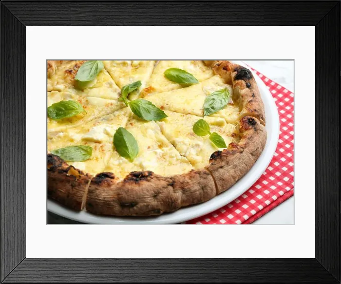Framed Print : Delicious hot cheese pizza with basil on table, closeup Framed Print : Delicious hot cheese pizza with basil on table, closeup