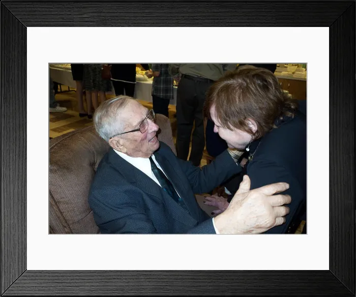 Framed Print : Woman age 75 greets her 95 year old cousin at his birthday party. Redwood Falls Minnesota MN USA Framed Print : Woman age 75 greets her 95 year old cousin at his birthday party. Redwood Falls Minnesota MN USA