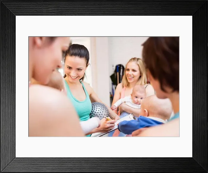 Framed Print : Group exercise class, mother working out with baby in gym