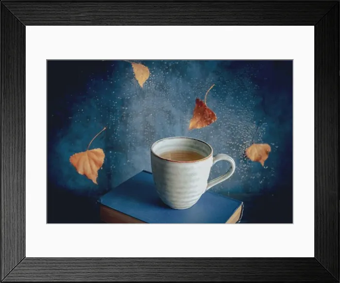 Framed Print : Reading in autumn, a still life with a cup of tea, falling leaves and raindrops, toned image Framed Print : Reading in autumn, a still life with a cup of tea, falling leaves and raindrops, toned image