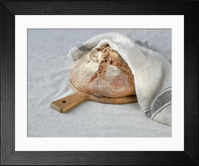 Framed Print : No knead handmade loaf on cutting board on textile with linen towel Framed Print : No knead handmade loaf on cutting board on textile with linen towel