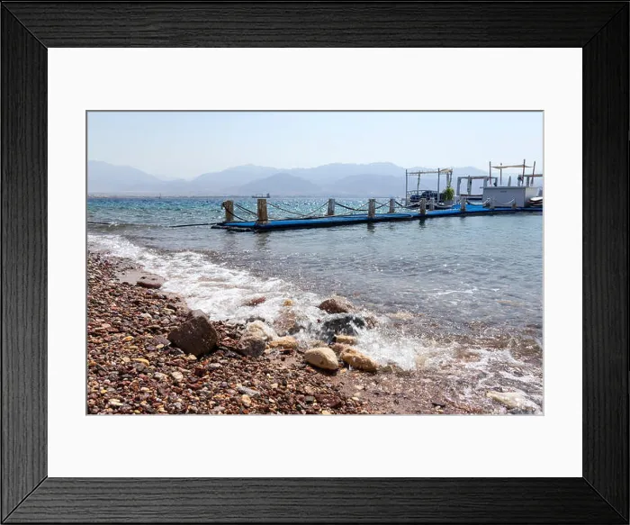 Framed Print : Rocky beach with a floating pier in the Gulf of Eilat Red Sea. Israel