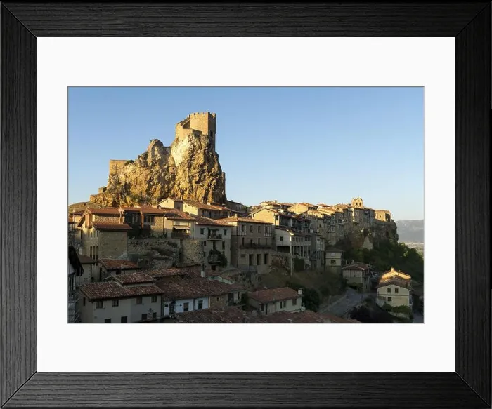 Framed Print : Medieval old town placed on rocky mountain with fortress on top in bright sunlight against blue sky Framed Print : Medieval old town placed on rocky mountain with fortress on top in bright sunlight against blue sky
