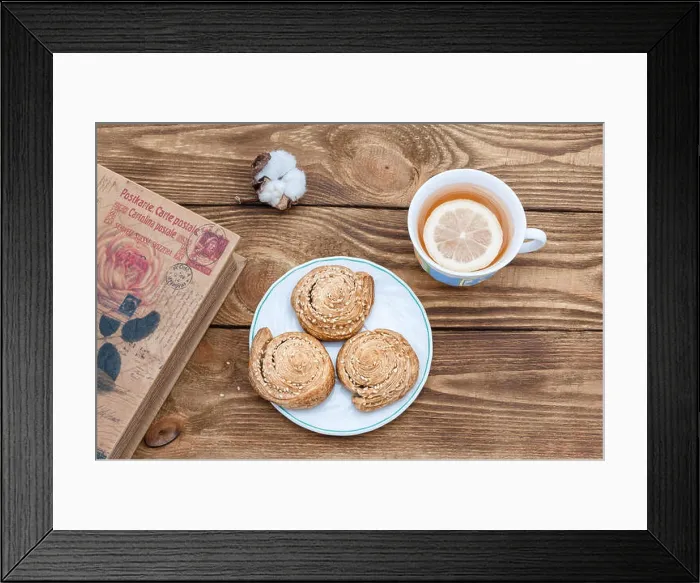 Framed Print : Tea with lemon and homemade cookies and a book on a wooden table Framed Print : Tea with lemon and homemade cookies and a book on a wooden table