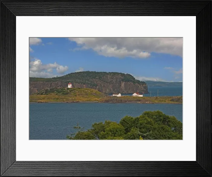 Framed Print : A scenic view of the Fort Point lighthouse standing on a small hill next to the coastal village of Trinity