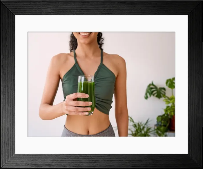 Framed Print : A beautiful multi-ethnic woman smiles with green juice - spinach, kale, vitamans Framed Print : A beautiful multi-ethnic woman smiles with green juice - spinach, kale, vitamans