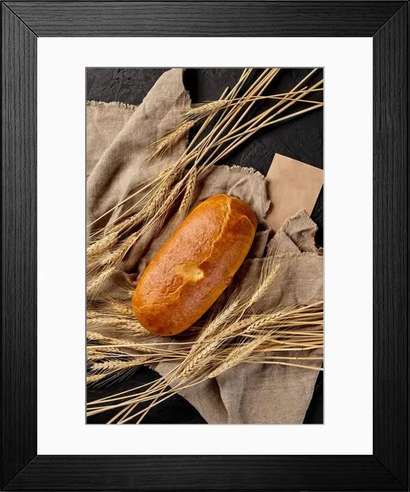 Framed Print : Loaf of freshly baked bread on cut of burlap with ears of wheat on black background Framed Print : Loaf of freshly baked bread on cut of burlap with ears of wheat on black background