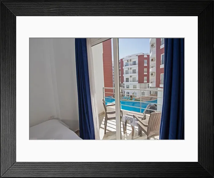 Framed Print : Interior design decor furnishing of luxury show home bedroom showing furniture and double bed with balcony