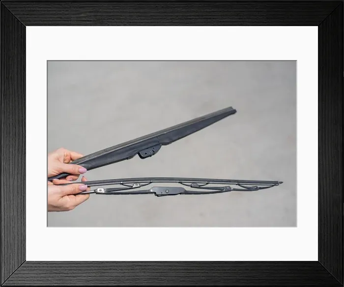 Framed Print : Close-up of female hands with summer and winter windshield wipers. Seasonal change of vehicle equipment Framed Print : Close-up of female hands with summer and winter windshield wipers. Seasonal change of vehicle equipment