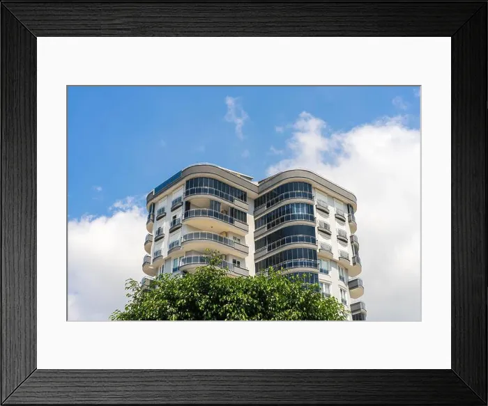 Framed Print : Exterior of a high-rise apartment building. Large balconies. Sunny day. Residential Properties