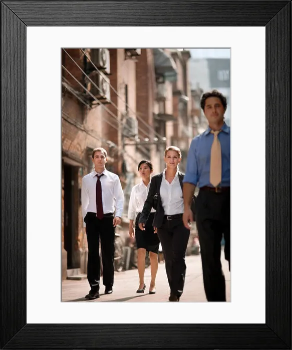 Framed Print : Portrait of four business colleagues walking side by side down a city street Framed Print : Portrait of four business colleagues walking side by side down a city street