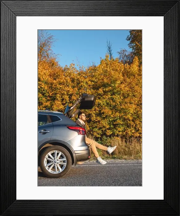 Framed Print : A man sits in the trunk of his car and enjoys the autumn sun as he basks in it Framed Print : A man sits in the trunk of his car and enjoys the autumn sun as he basks in it