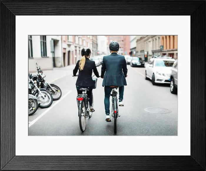 Framed Print : Rear view of business people riding bicycles on street Framed Print : Rear view of business people riding bicycles on street
