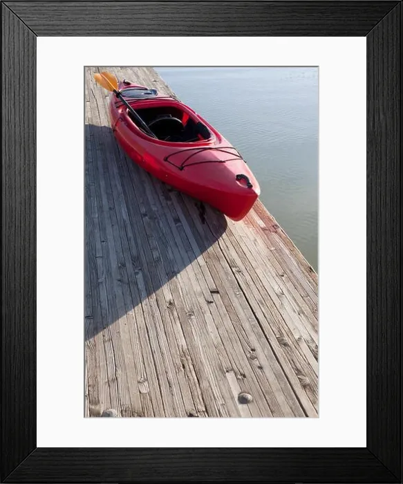 Framed Print : High angle view of kayak and paddle on wooden pier next to water Framed Print : High angle view of kayak and paddle on wooden pier next to water