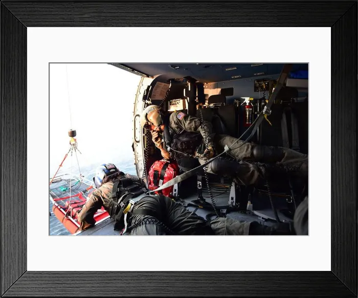 Framed Print : Petty Officer 2nd Class Benjamin Davis retrieves a rescue basket while Petty Officer 2nd Class Tyler Johnson checks Framed Print : Petty Officer 2nd Class Benjamin Davis retrieves a rescue basket while Petty Officer 2nd Class Tyler Johnson checks