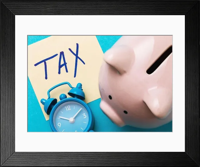 Framed Print : Piggy bank, alarm clock and a sheet of paper with the inscription on a blue background. Tax payment concept Framed Print : Piggy bank, alarm clock and a sheet of paper with the inscription on a blue background. Tax payment concept