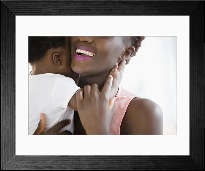 Framed Print : Close up of Black mother holding son Framed Print : Close up of Black mother holding son