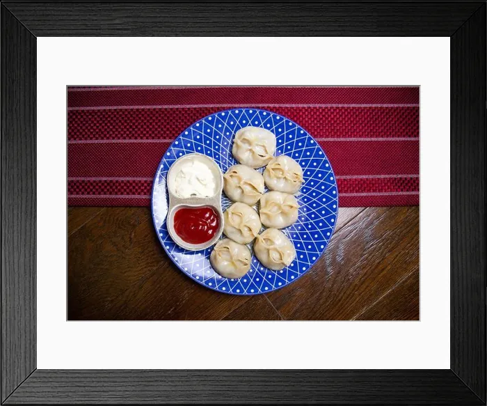 Framed Print : manti and sauce on a blue plate top view