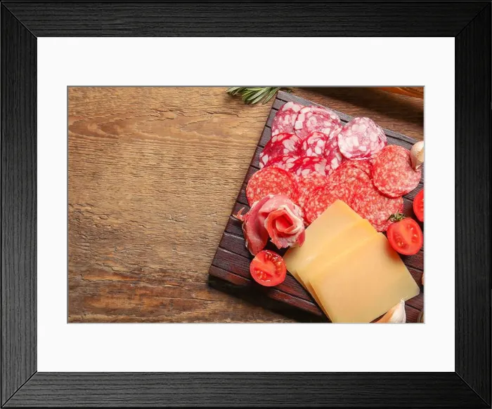Framed Print : Board with assortment of tasty deli meats and cheese on wooden background Framed Print : Board with assortment of tasty deli meats and cheese on wooden background