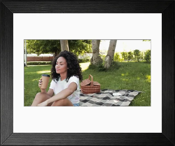Framed Print : young african american woman holding coffee to do during picnic in park Framed Print : young african american woman holding coffee to do during picnic in park