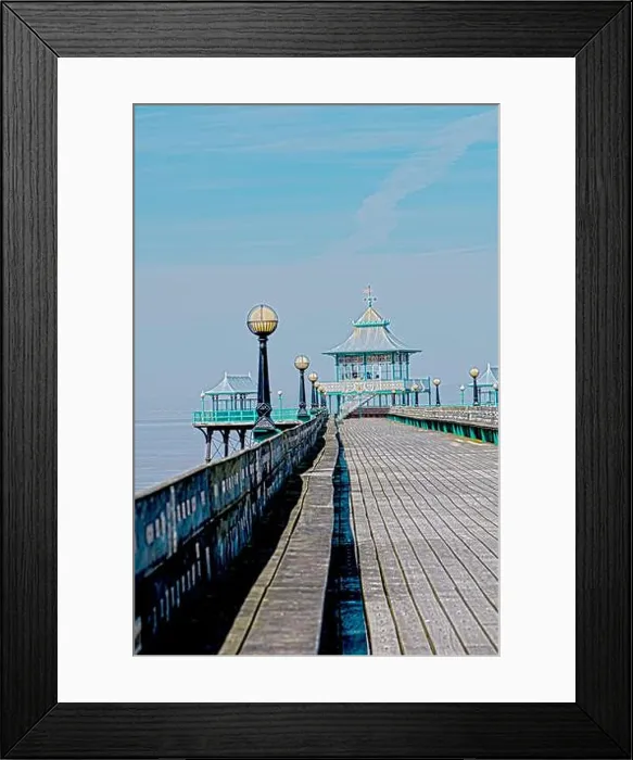 Framed Print : A long wooden pier stretches out into the water Framed Print : A long wooden pier stretches out into the water