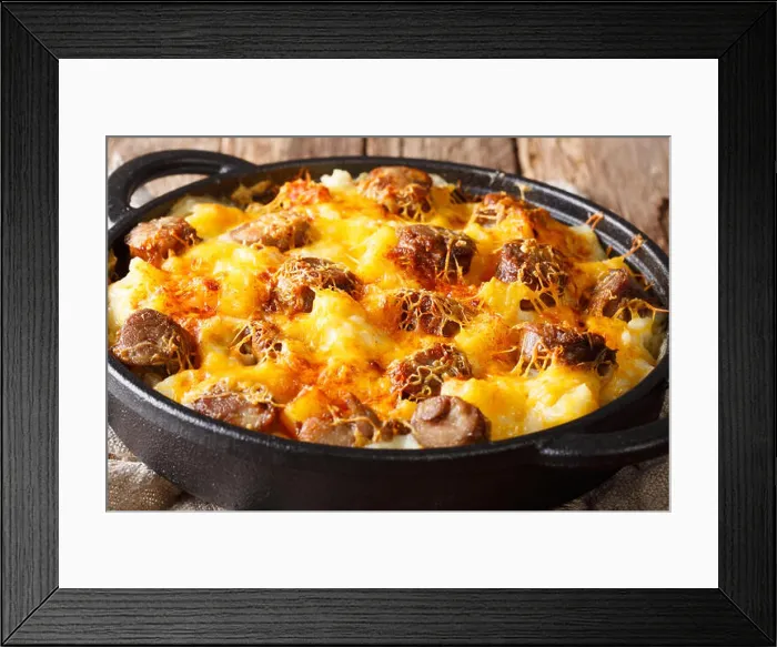 Framed Print : Hot Jolean's potato casserole, smoked sausages with cheese sauce close-up in a frying pan on the table. horizontal Framed Print : Hot Jolean's potato casserole, smoked sausages with cheese sauce close-up in a frying pan on the table. horizontal
