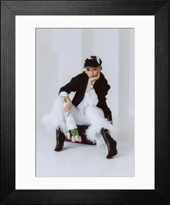Framed Print : A stylish young woman in a light suit with feathers Framed Print : A stylish young woman in a light suit with feathers